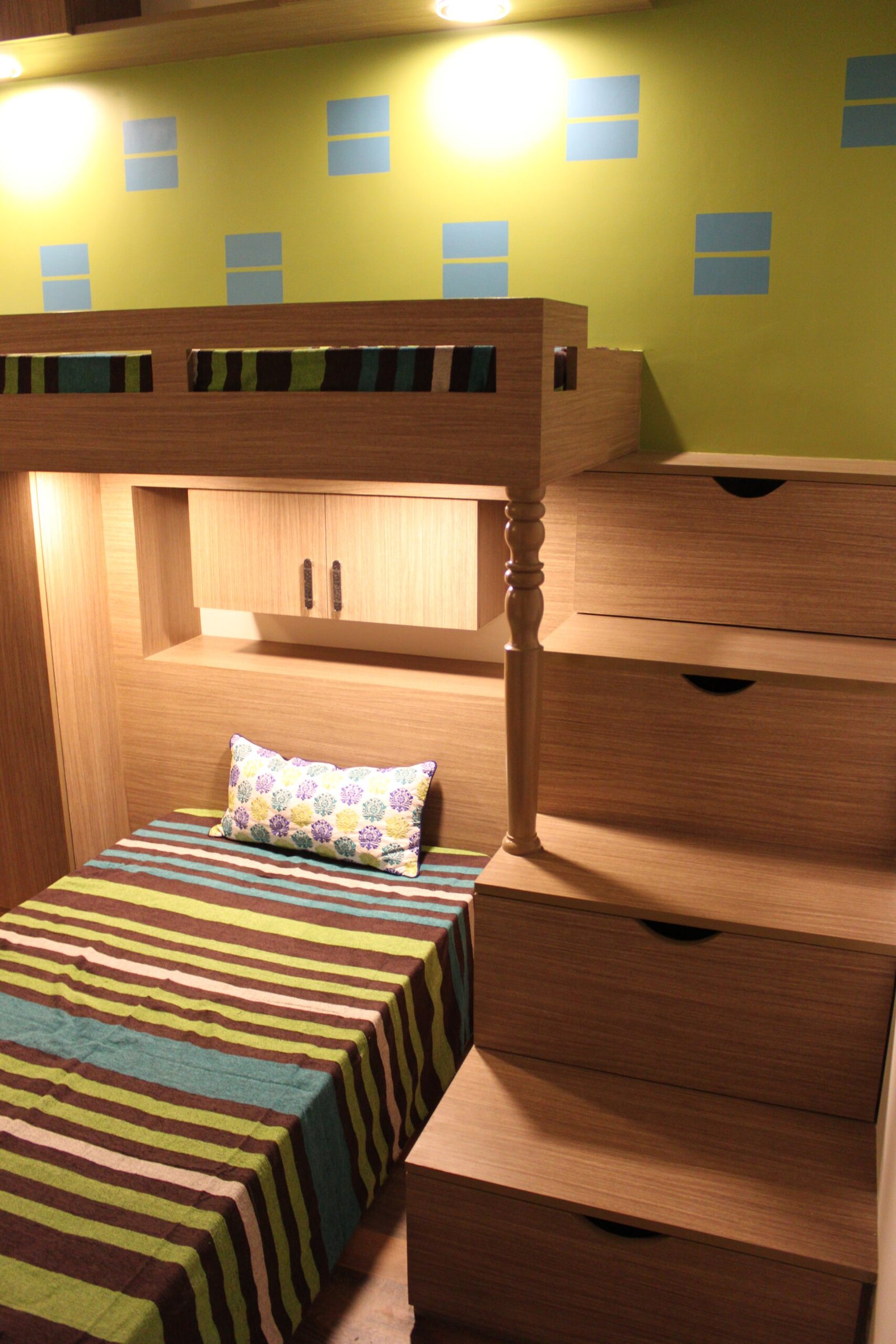 Bunk bed with striped bedding in wood